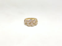 In the center: a 10 karat yellow gold challah braid link lady's ring set with cubic zirconia in a micropave style made by Popular Jewelry