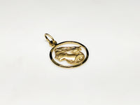 In the center: a framed profile of a blindfolded Lady Justice medallion style pendant in 14 karat yellow gold laying flat facing upangle made by Popular Jewelry in New York City