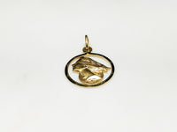 In the center: a framed profile of a blindfolded Lady Justice medallion style pendant in 14 karat yellow gold laying flat facing up made by Popular Jewelry in New York City