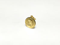 In the center: a portrait of Mary looking downher son Jesus in a 14 karat yellow gold medallion style pendant standing up facing vieweran angle made by Popular Jewelry in New York City