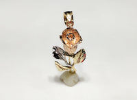 In the center: a large (42.5 mm) long stemmed rose pendant in 14 karat gold with rose gold petals standing up facing viewer made by Popular Jewelry in New York City