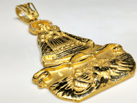 A 45 angle view from bottom of Our Lady of Charity "Cardidad" 14K Yellow Gold Pendant laying flat - Popular Jewelry
