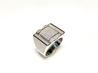 In the center: white sterling silver men's rings set with cubic zirconia in a micro pave setting standing upangle view made by Popular Jewelry in New York City