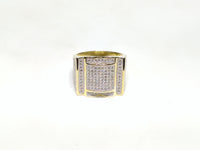 In the center: yellow sterling silver men's rings set with cubic zirconia in a micro pave setting laying down viewer made by Popular Jewelry in New York City