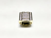 In the center: yellow sterling silver men's rings set with cubic zirconia in a micro pave setting standing up facing viewer made by Popular Jewelry in New York City