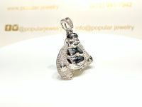 In the center: a sterling silver Seated Laughing Buddha Pendant iced out with cubic zirconia set in micropave style facing 45 degrees made by Popular Jewelry in New York City