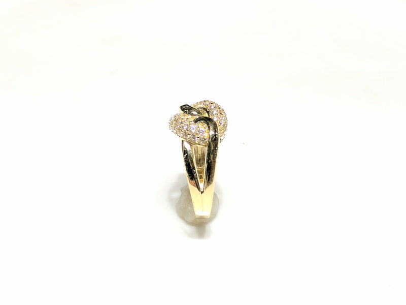 In the center: 10 karat yellow gold lady's puffy round link ring set with cubic zirconia in micro pave setting standing up with its side facing the viewer made by Popular Jewelry