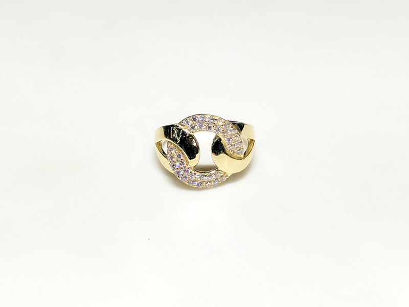 In the center: a 10 karat yellow gold lady's ring in the shape of a flat round link set with cubic zirconia in a micro pave setting laying on its side facing viewer made by Popular Jewelry in New York City