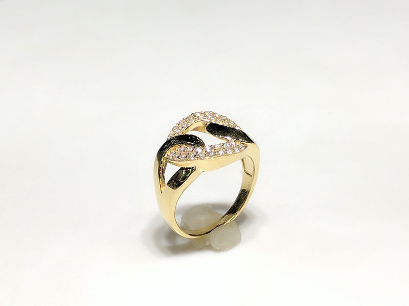 In the center: a 10 karat yellow gold lady's ring in the shape of a flat round link set with cubic zirconia in a micro pave setting standing up facing vieweran angle made by Popular Jewelry in New York City