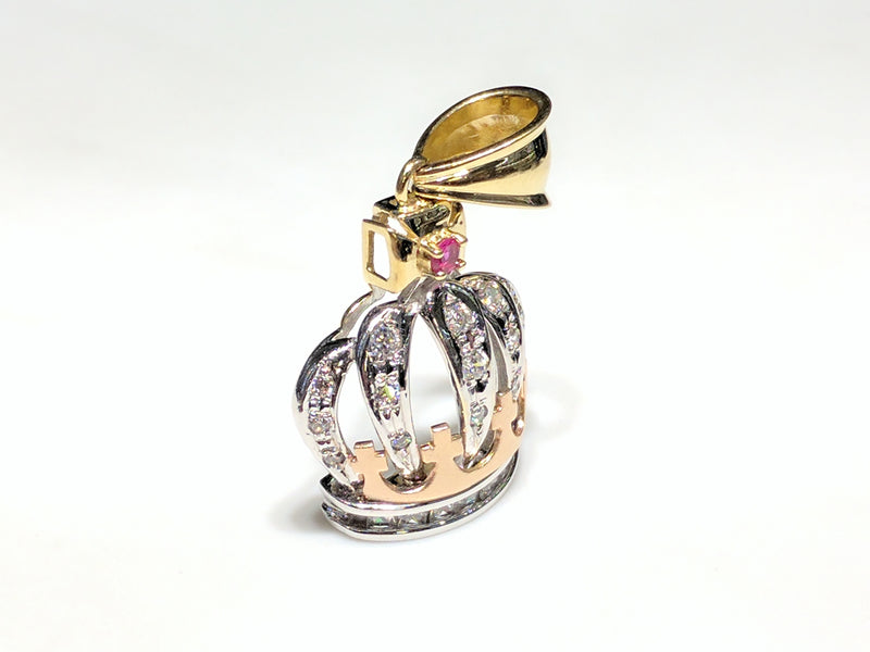 In the center: a 14K rose, white, and yellow gold king's crown pendant set with round and princess cut cubic zirconia standing angle view made by Popular Jewelry