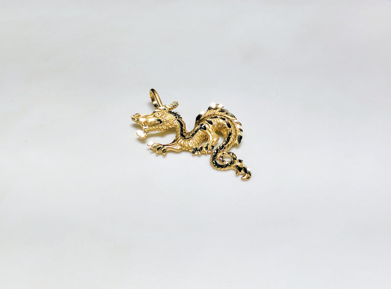In the center: a 14 karat yellow gold diamond cut eastern asian dragon laying flat in angle view - Popular Jewelry