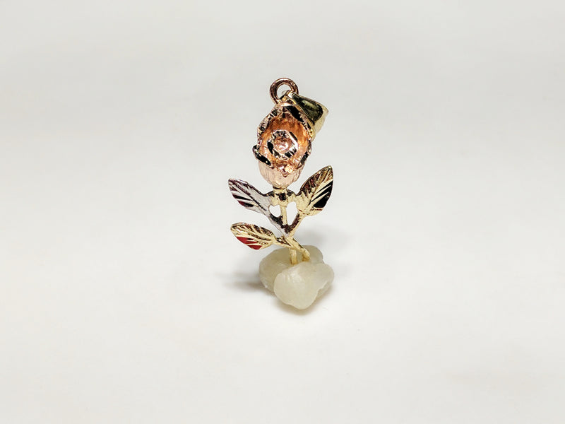 In the center: a small (36 mm) long stemmed rose pendant in 14 karat gold with rose gold petals standing up facing viewer made by Popular Jewelry in New York City