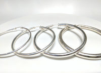 From left to right: sterling silver hoop earrings in plain high polished finish of different thicknesses arranged from thinnest to thickest - Popular Jewelry