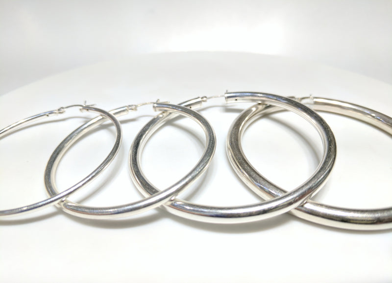 From left to right: sterling silver hoop earrings in plain high polished finish of different thicknesses arranged from thinnest to thickest - Popular Jewelry