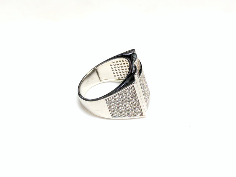 In the center: white sterling silver men's rings set with cubic zirconia in a micro pave setting laying flat side view made by Popular Jewelry in New York City