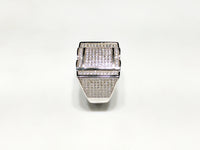 In the center: white sterling silver men's rings set with cubic zirconia in a micro pave setting standing up side view made by Popular Jewelry in New York City