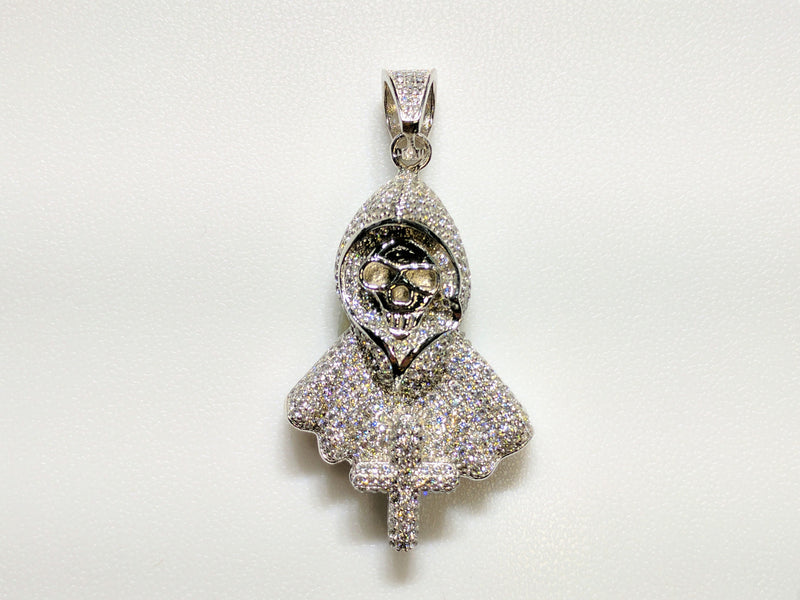 In the center: a white sterling silver hooded skeleton iced out with cubic zirconia in a beautiful micro pave setting made by Popular Jewelry in New York City