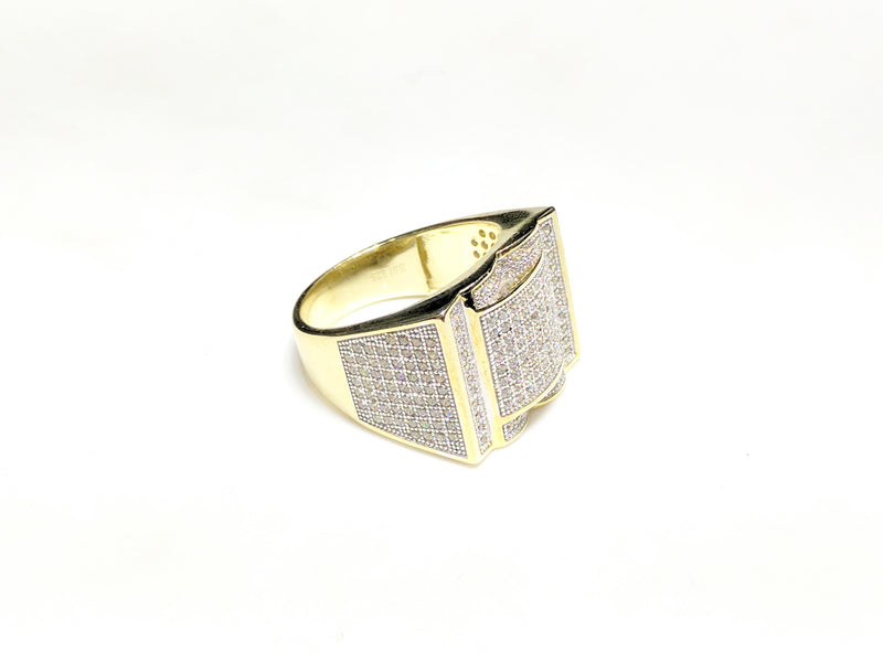 In the center: yellow sterling silver men's rings set with cubic zirconia in a micro pave setting laying flatangle view made by Popular Jewelry in New York City