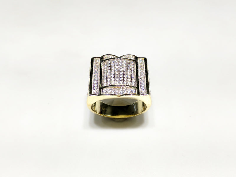 In the center: yellow sterling silver men's rings set with cubic zirconia in a micro pave setting standing up facing viewer made by Popular Jewelry in New York City