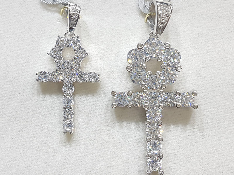 Two sterling silver ankh pendants side by side set with cubic zirconia in direct view - Popular Jewelry